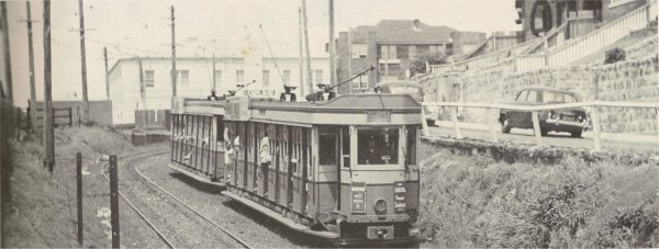 Tram coming down to Bondi Beach.  Bondi Beach YHA in the background