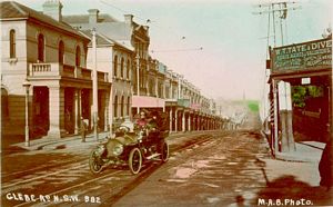 Glebe Point Road coloured postcard - strip shopping - tram tracks